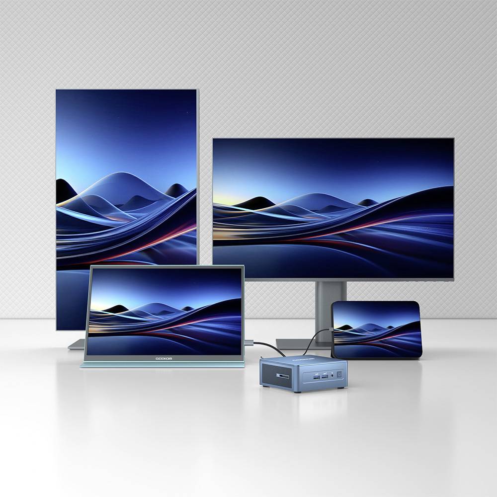 Mehrere Computermonitore in verschiedenen Größen zeigen ein abstraktes blaues Wellenmuster. Ein kleiner Computer vorne ist angeschlossen.