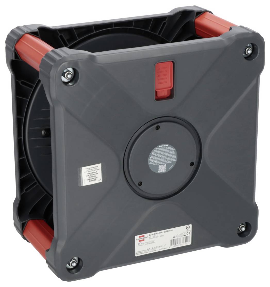 Ein quadratischer, grauer Kabeltrommelkasten mit roten Griffen an den Ecken und einer zentralen roten Taste auf der Oberseite.