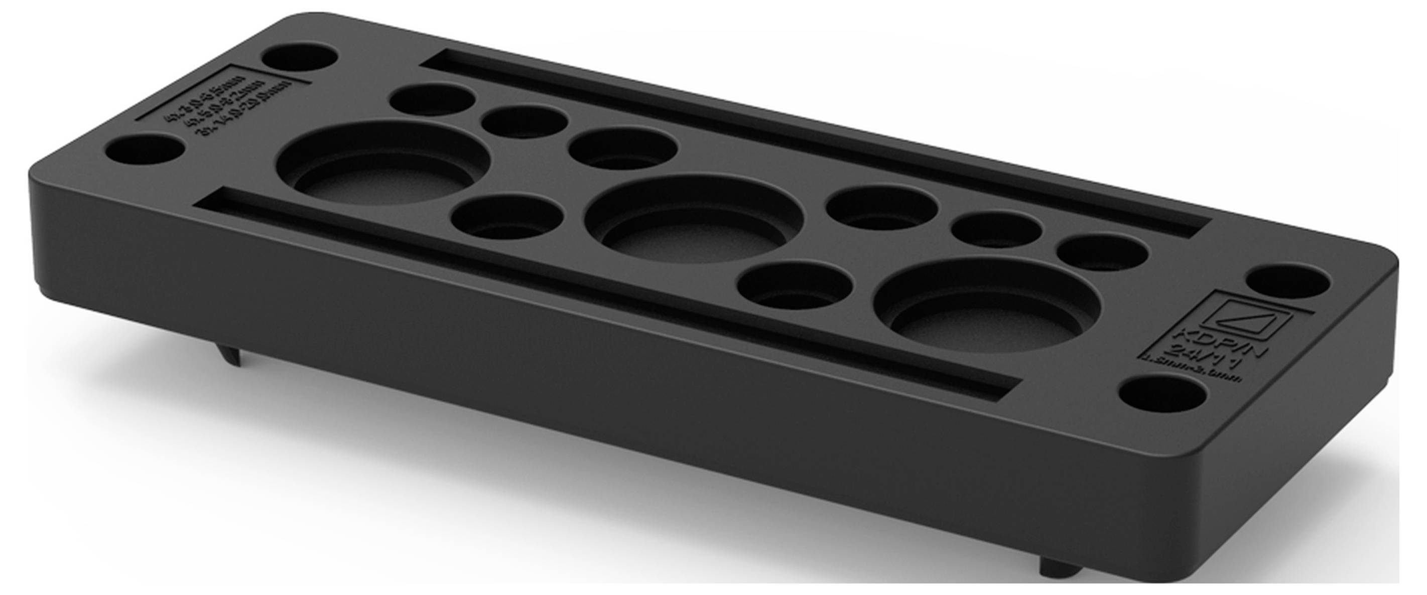 Schwarzes Kunststoffteil mit zahlreichen runden Aussparungen unterschiedlicher Größe in zwei Reihen. Flaches Design, rechteckige Form.