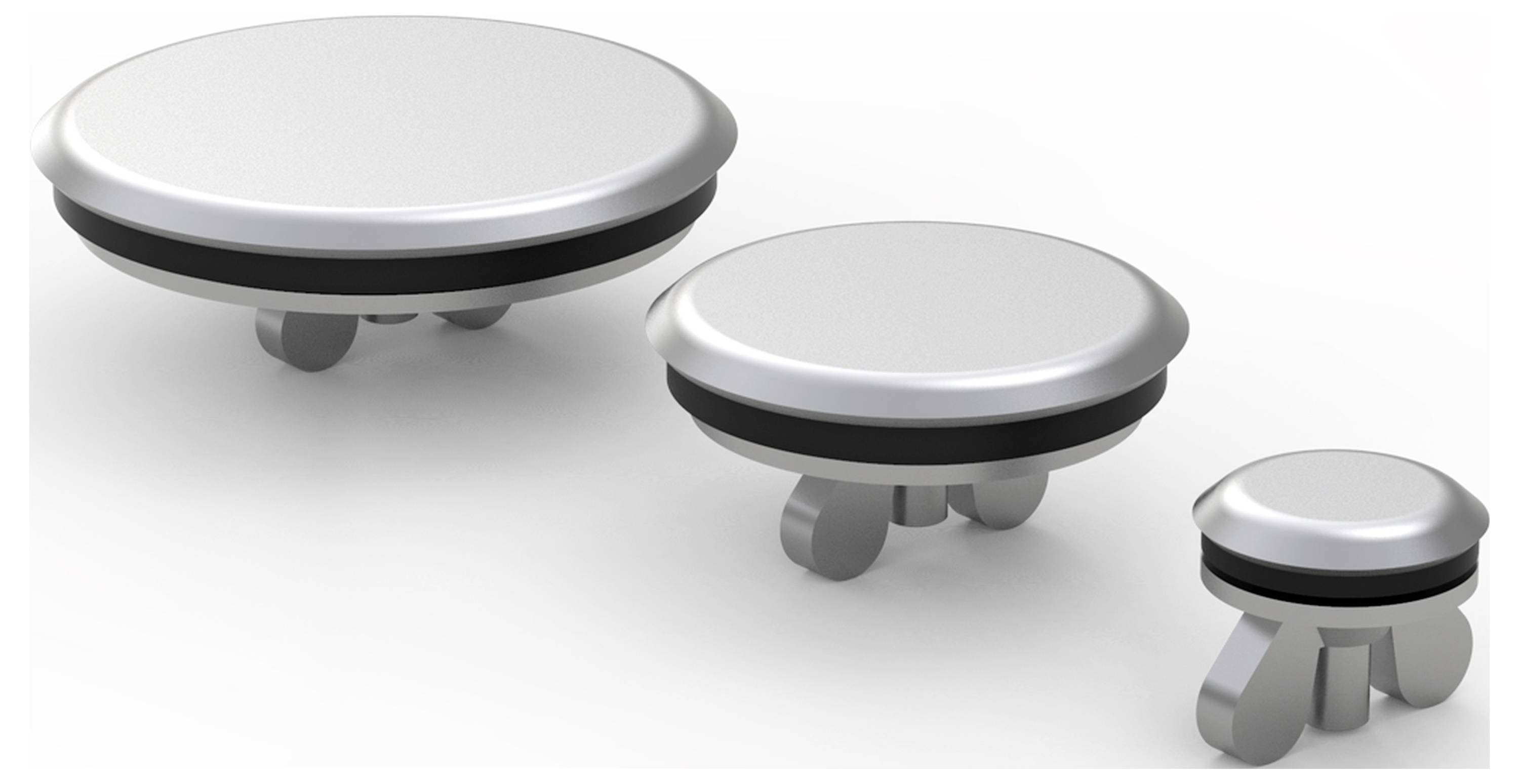 Drei unterschiedlich große, silberne Stopfen mit Gummiabdichtung und Rastfüßen für Löcher in Arbeitsplatten.