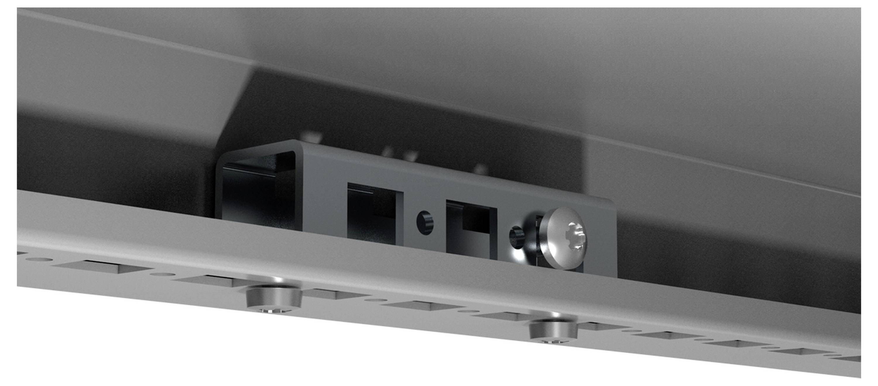 Eine Nahaufnahme eines Metallgehäuses mit einem gerändelten Knopf und Schienen, möglicherweise ein Teil eines Schiebe- oder Verriegelungsmechanismus.