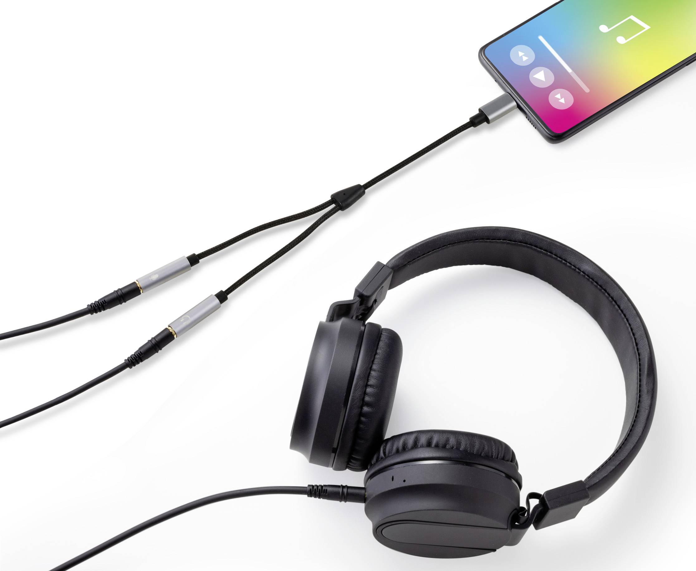 Smartphone mit Musik-App ist über Splitter mit zwei Kabeln verbunden; ein Kabel führt zu schwarzen Over-Ear-Kopfhörern.