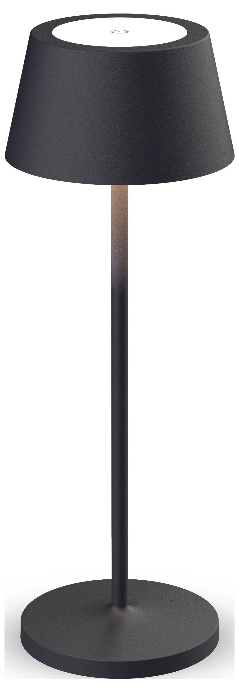 Schwarze Tischlampe mit zylindrischem Sockel und schrägem Schirm, der warmes Licht nach unten abstrahlt.