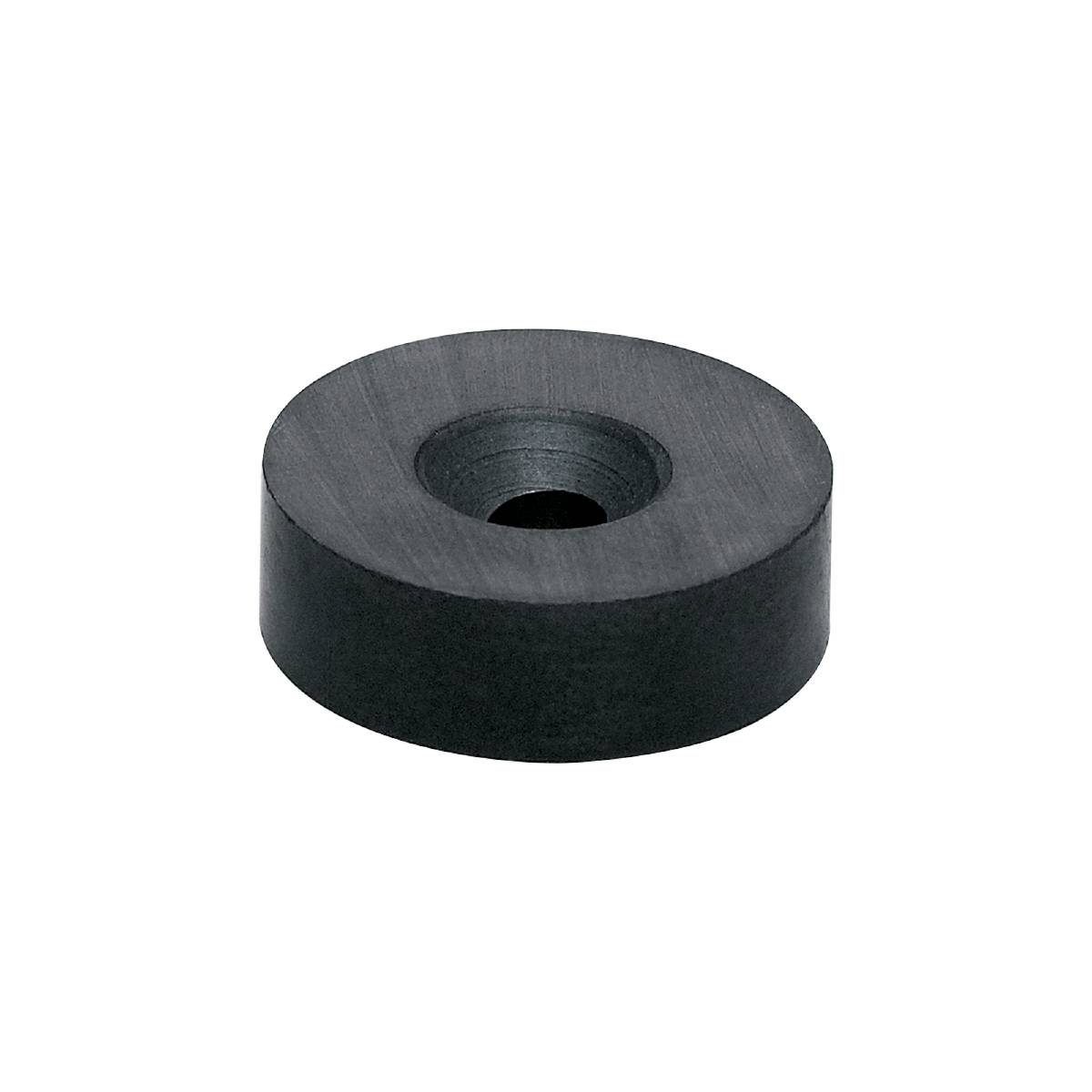 Ein einzelner, schwarzer, scheibenförmiger Magnet vor einem schwarzen Hintergrund.
