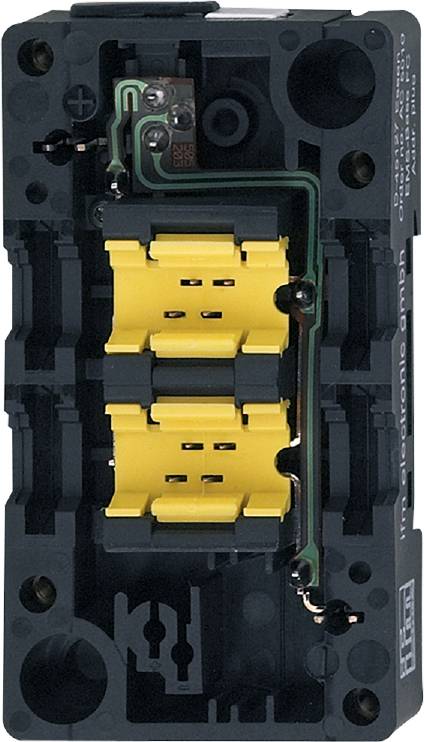 Schwarze elektrische Komponente mit gelben Steckverbindungen, möglicherweise Teil eines größeren elektrischen Geräts oder Schalters.