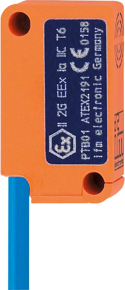 Ein orangefarbenes elektronisches Gerät mit blauer Leitung und weißem Text, das vermutlich Teil eines industriellen Systems ist.