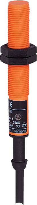 Ein oranger Sensor mit schwarzem Etikett, das technische Angaben enthält.