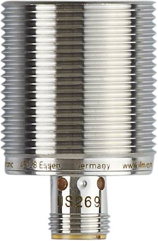 Ein silberner zylindrischer Sensor mit Schraubengewinde und Markierung 'Germany' am unteren Rand. Hintergrund unscharf.