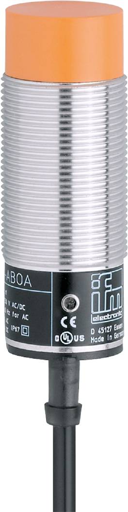 Ein zylindrischer, metallischer Sensor mit einem schwarzen Gehäuseteil, auf dem das Logo und technische Daten einer Elektronikfirma abgebildet sind.