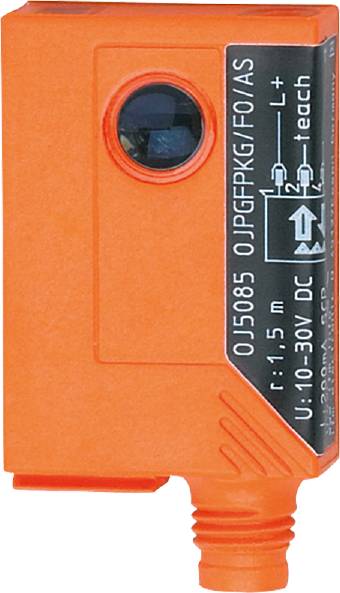 Nahaufnahme eines orangefarbenen elektronischen Sensors mit technischer Spezifikation auf einem schwarzen Etikett.