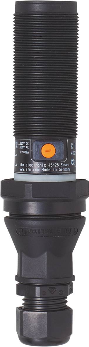 Nahaufnahme eines schwarzen zylindrischen Sensors mit orangefarbenem Knopf und Aufschrift 'Made in Germany'.