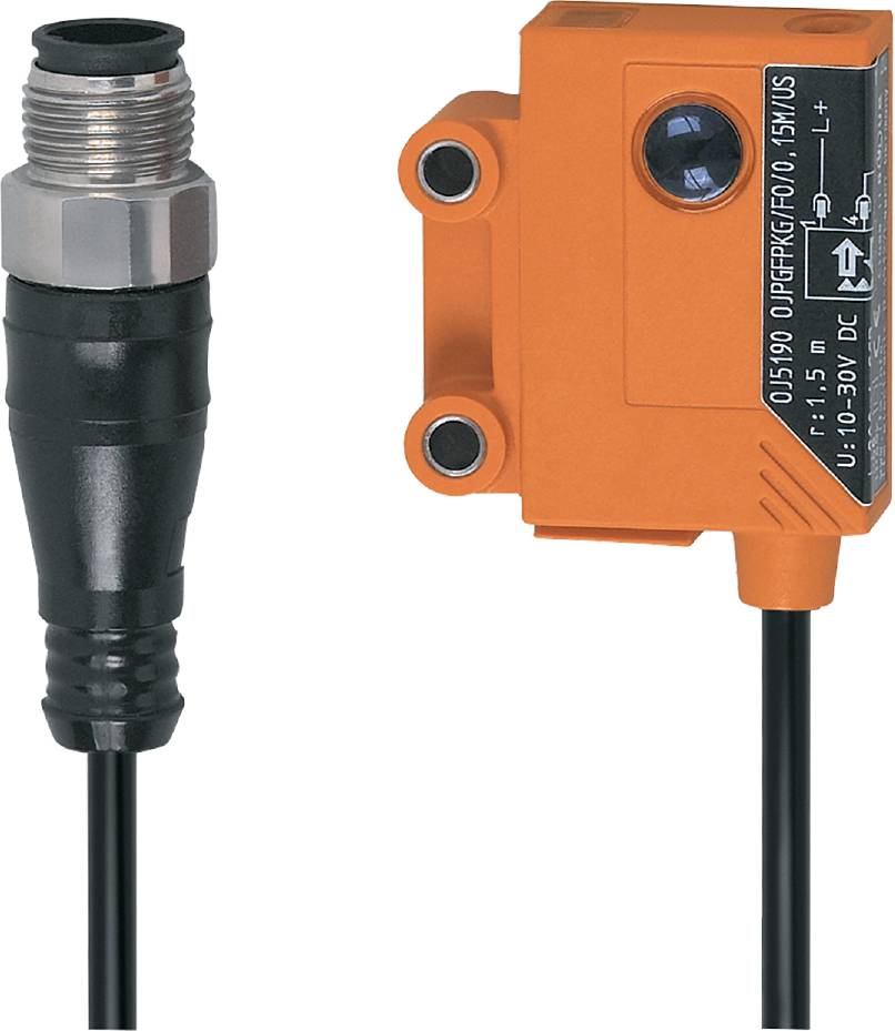 Ein rechteckiger, orangefarbener Sensor mit Kabelanschluss und Schraubverbindung. Text auf dem Sensor: 'FR: 15m, 10-30V DC'.