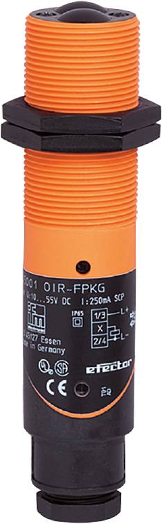 Ein orangefarbener, zylindrischer Sensor mit schwarzem Etikett, technischer Text und Symbolen für elektrische Spezifikationen.