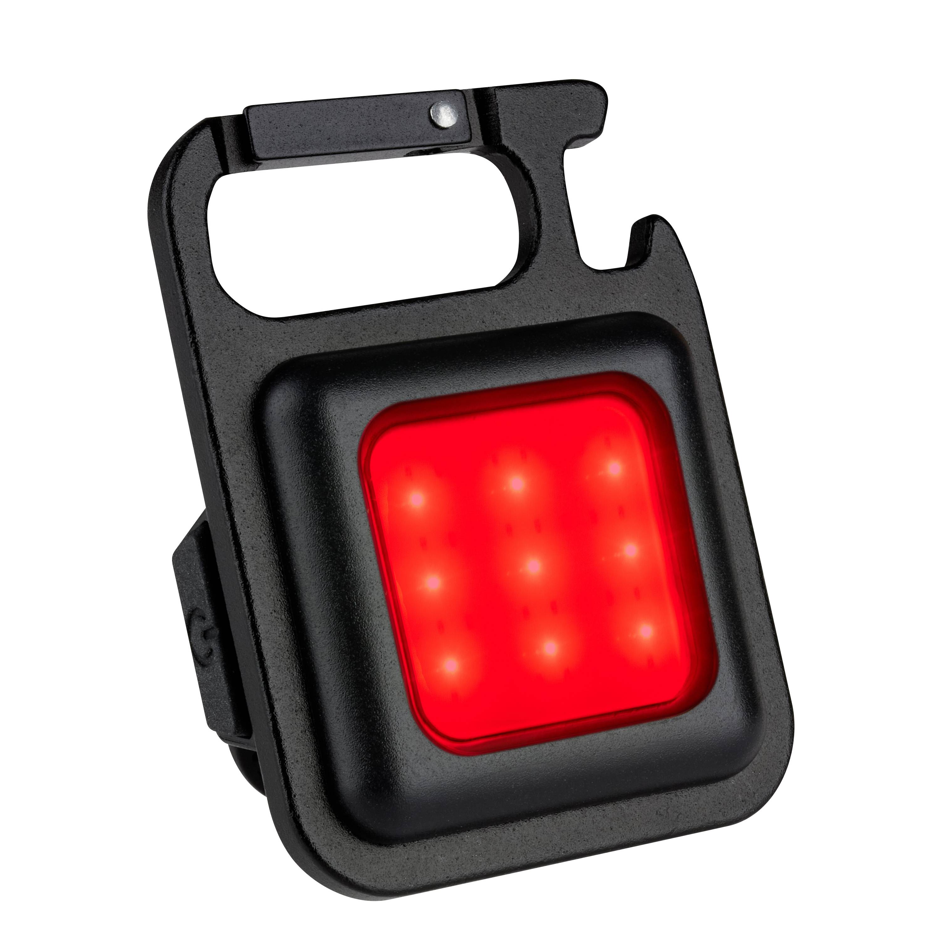 Ein kleiner, tragbarer LED-Lichterwürfel mit rotem Licht und neun leuchtenden Punkten, in einem schwarzen Gehäuse mit Clip-Halterung.
