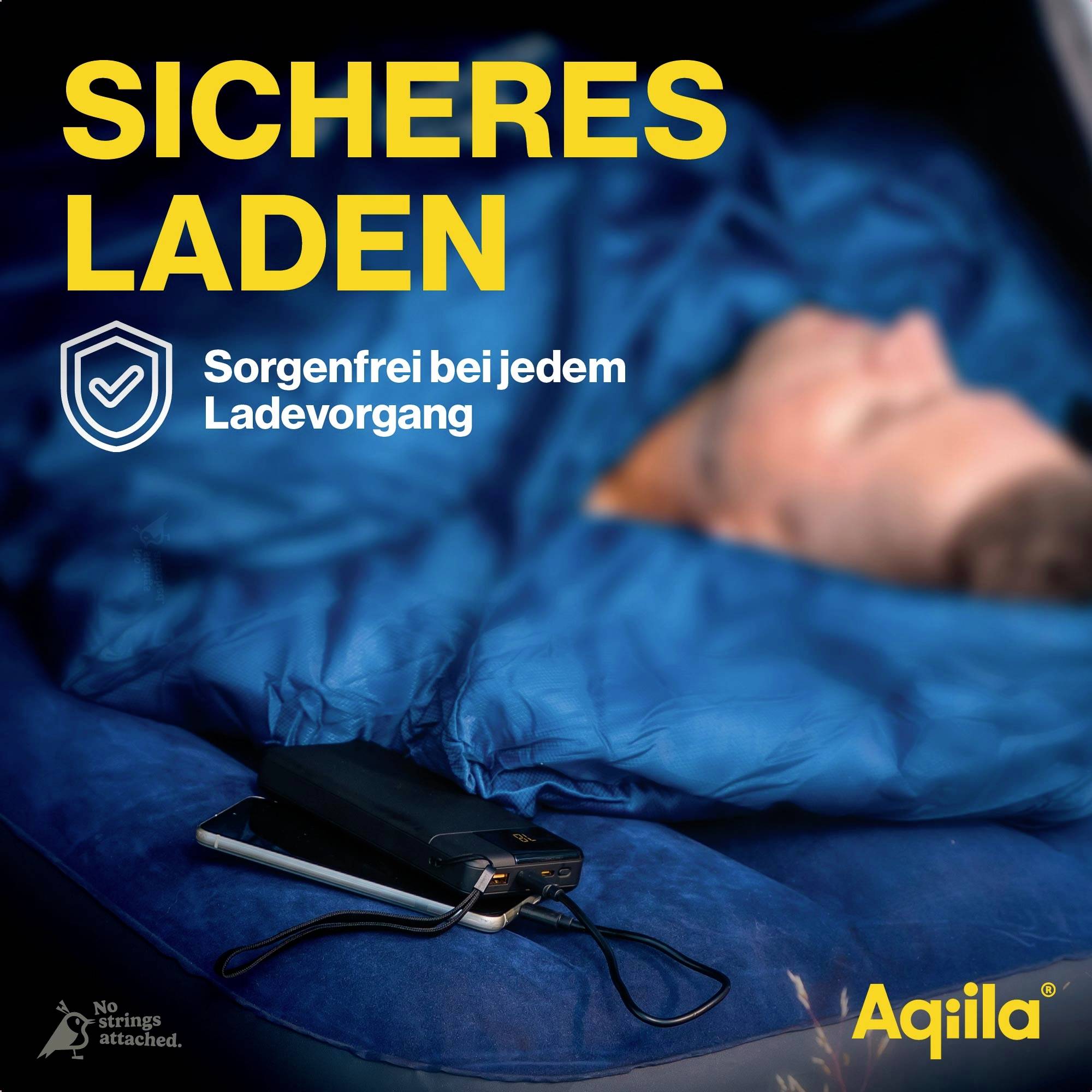 Ein Ladegerät liegt auf einer blauen Decke mit einem schlafenden Körper im Hintergrund. Text: Sicheres Laden - Sorgenfrei bei jedem Ladevorgang.