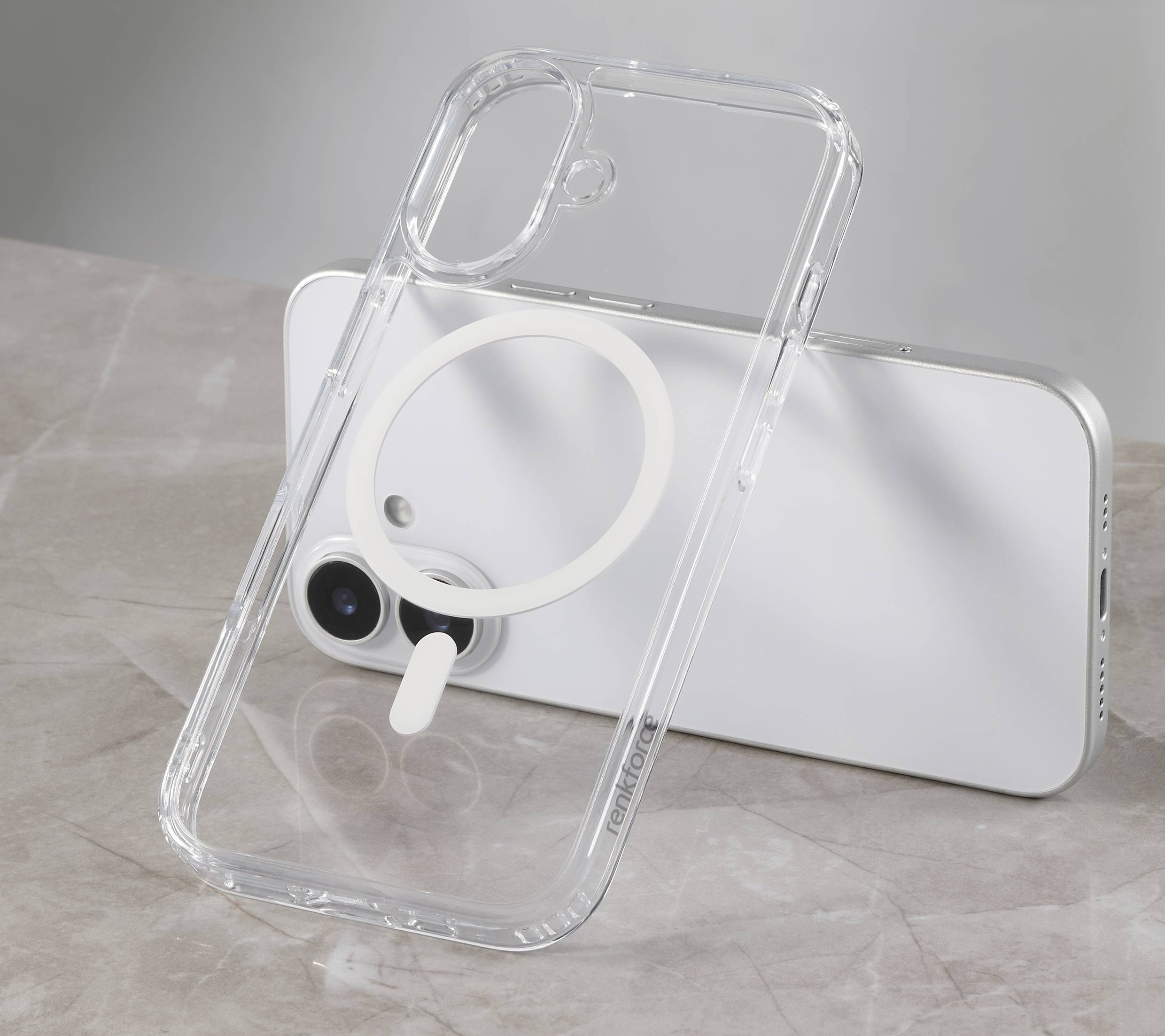 Smartphone in transparenter Hülle mit kreisförmigem Magneten auf Marmortisch.