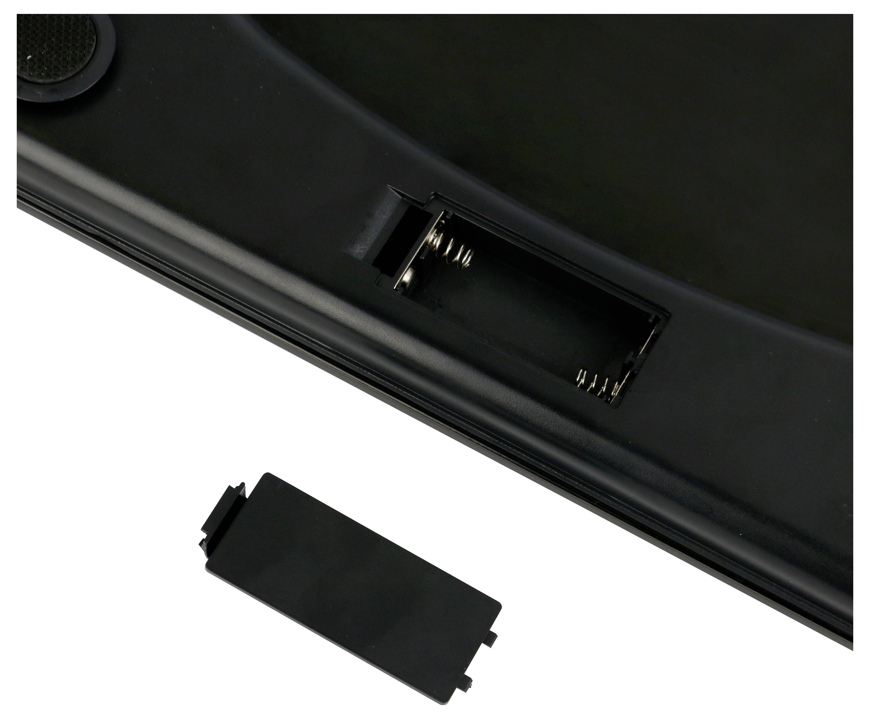 Leere Batteriefachöffnung einer elektronischen Waage mit abgenommener Abdeckung, zeigt federbelastete Kontakte.