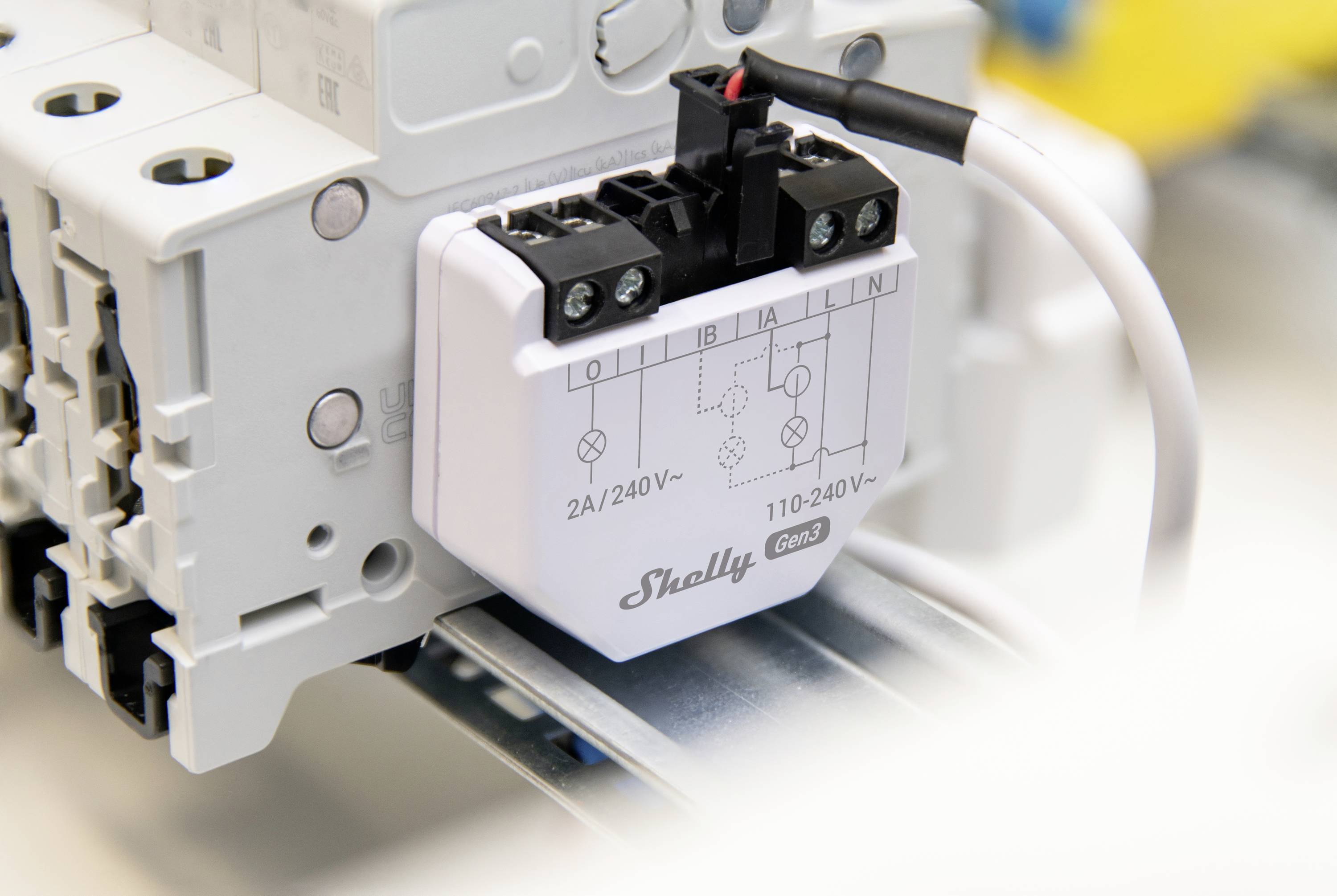 Ein elektrisches Relaismodul mit der Aufschrift 'Shelly 2A/240V'. Dient zur Steuerung von Stromkreisen auf einer Montageschiene.