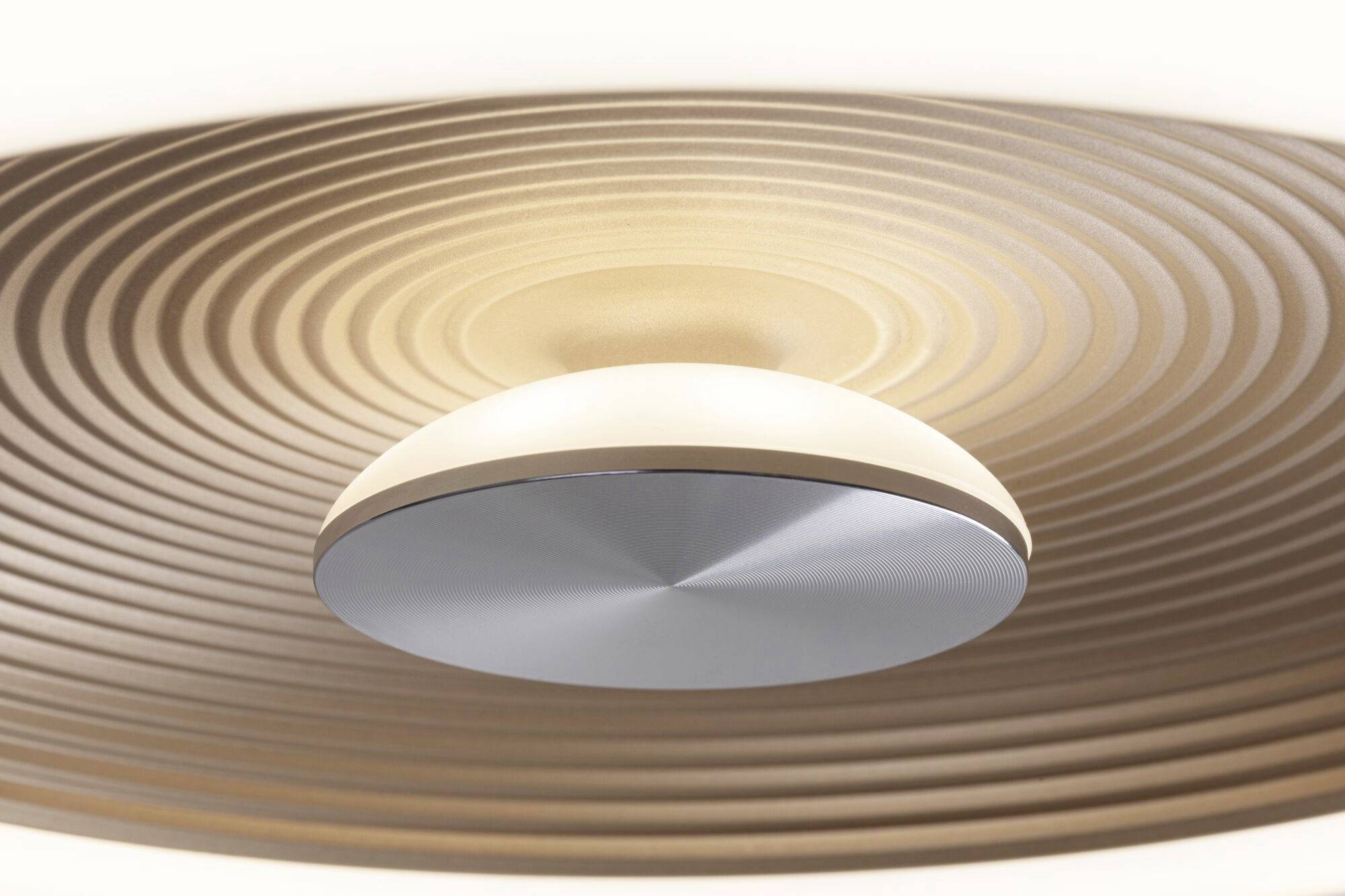 Eine moderne Deckenleuchte mit einem ringförmigen, spiralförmigen Design, die diffuses Licht abgibt und für eine stilvolle Beleuchtung sorgt.