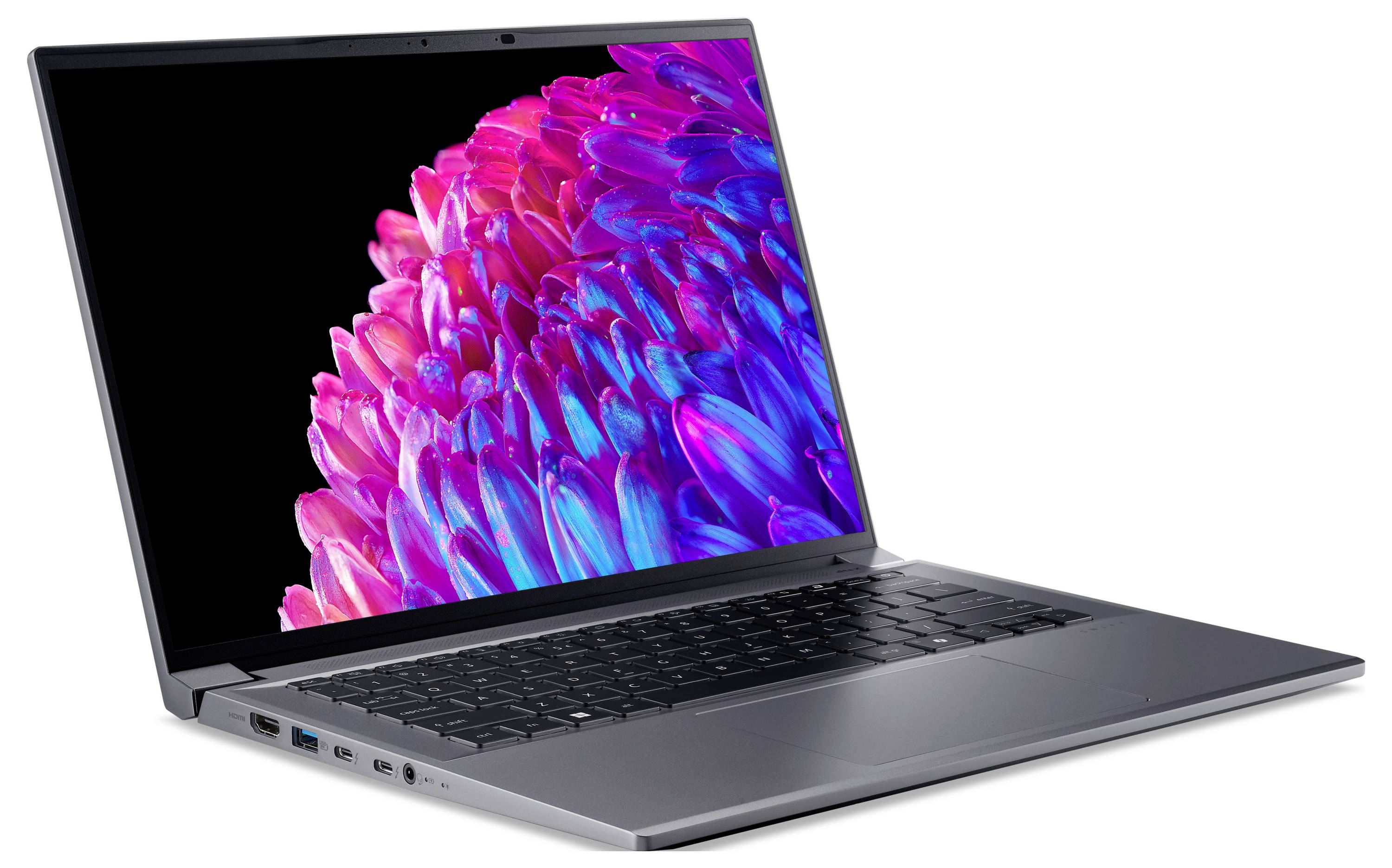 Ein Laptop mit geöffnetem Bildschirm zeigt ein leuchtendes, abstraktes Design in Pink- und Blautönen. Sichtbar sind Tastatur und Anschlüsse.