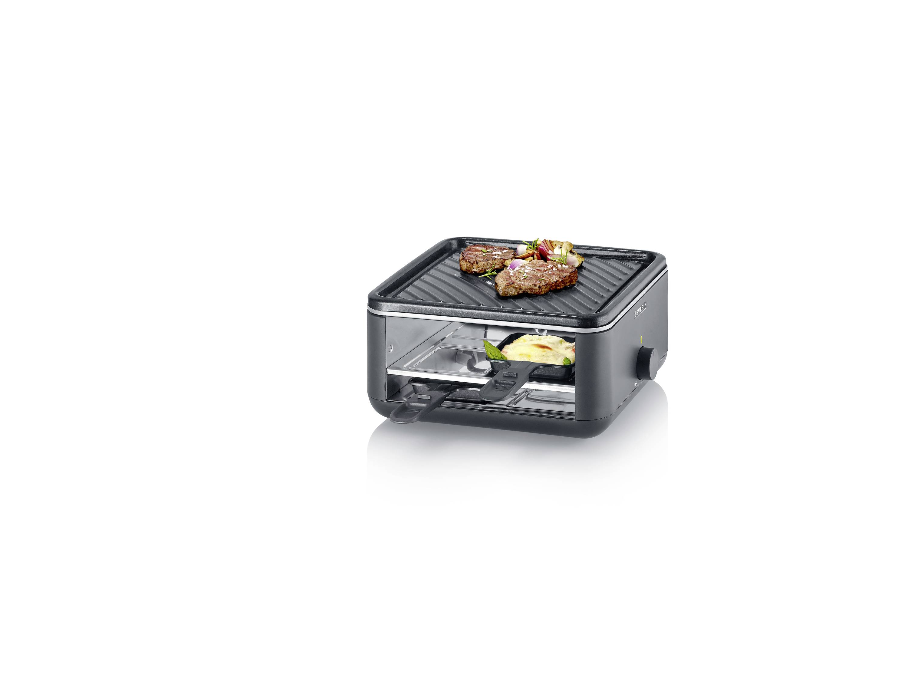 Ein kompakter Kontaktgrill mit zwei Fleischstücken oben, darunter eine Pfanne mit Gemüse. Geeignet zum gleichzeitigen Grillen und Kochen.