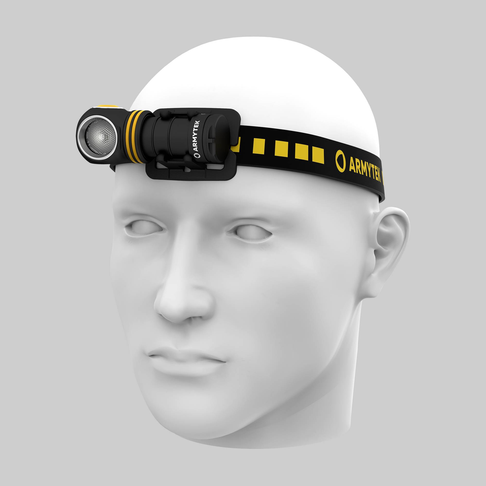 Eine weiße Kopfmodellbüste trägt eine schwarz-gelbe Stirnlampe mit der Aufschrift 'Armytek'.
