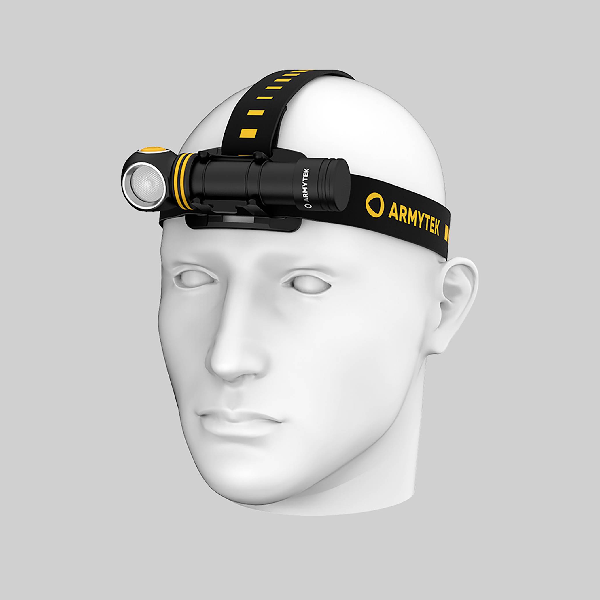 Ein weißer Kopfmodell trägt eine schwarze Stirnlampe mit gelben Akzenten der Marke 'Armytek'. Die Lampe ist an der Stirn befestigt.