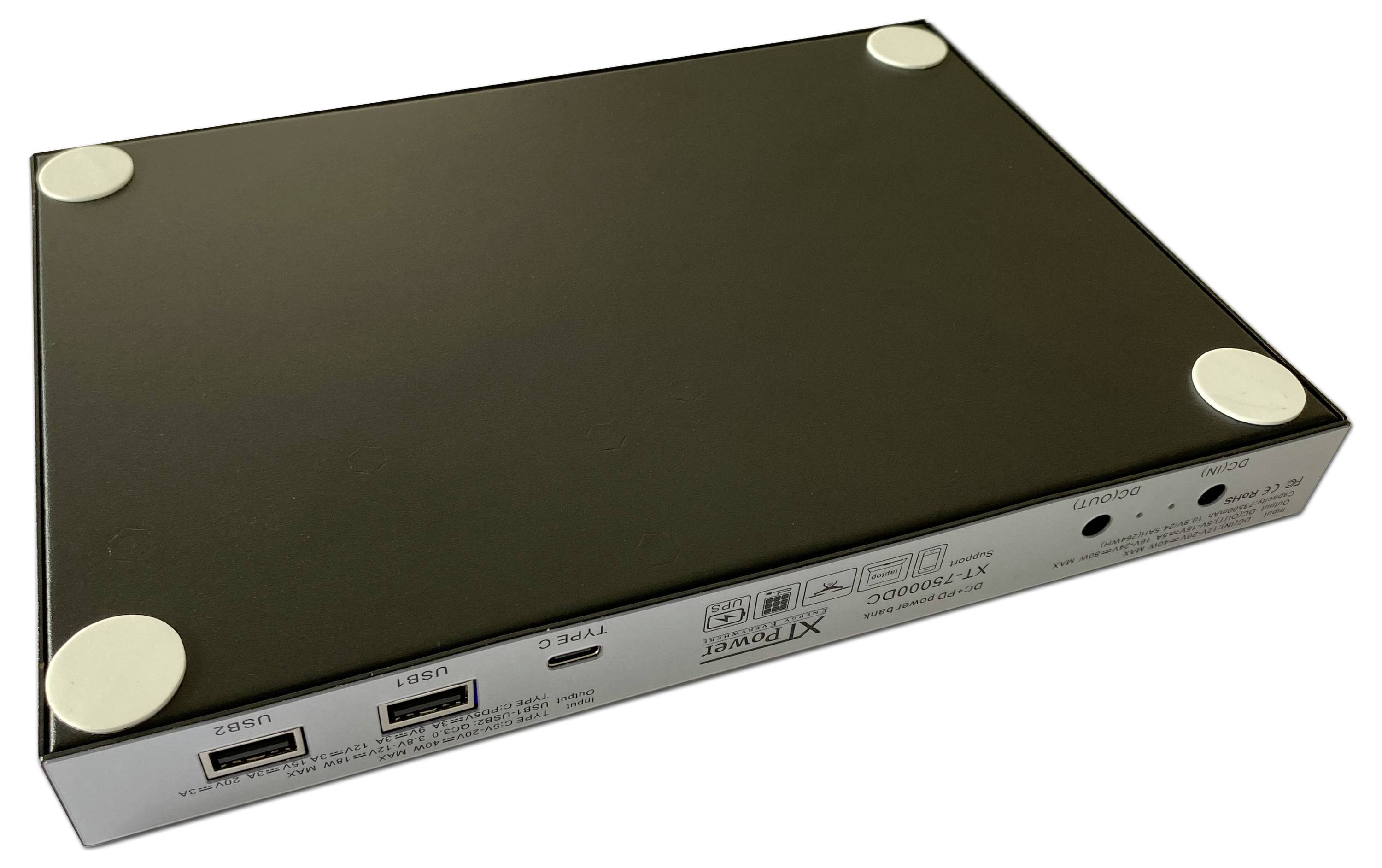 Ein rechteckiges, flaches elektronisches Gerät mit Anschlüssen auf einer Seite. Es hat vier runde Füße an den Ecken der Unterseite.