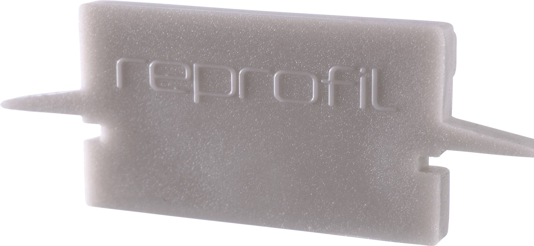 Ein graues Kunststoffteil mit der Aufschrift 'reprofil' in erhabenen Buchstaben.