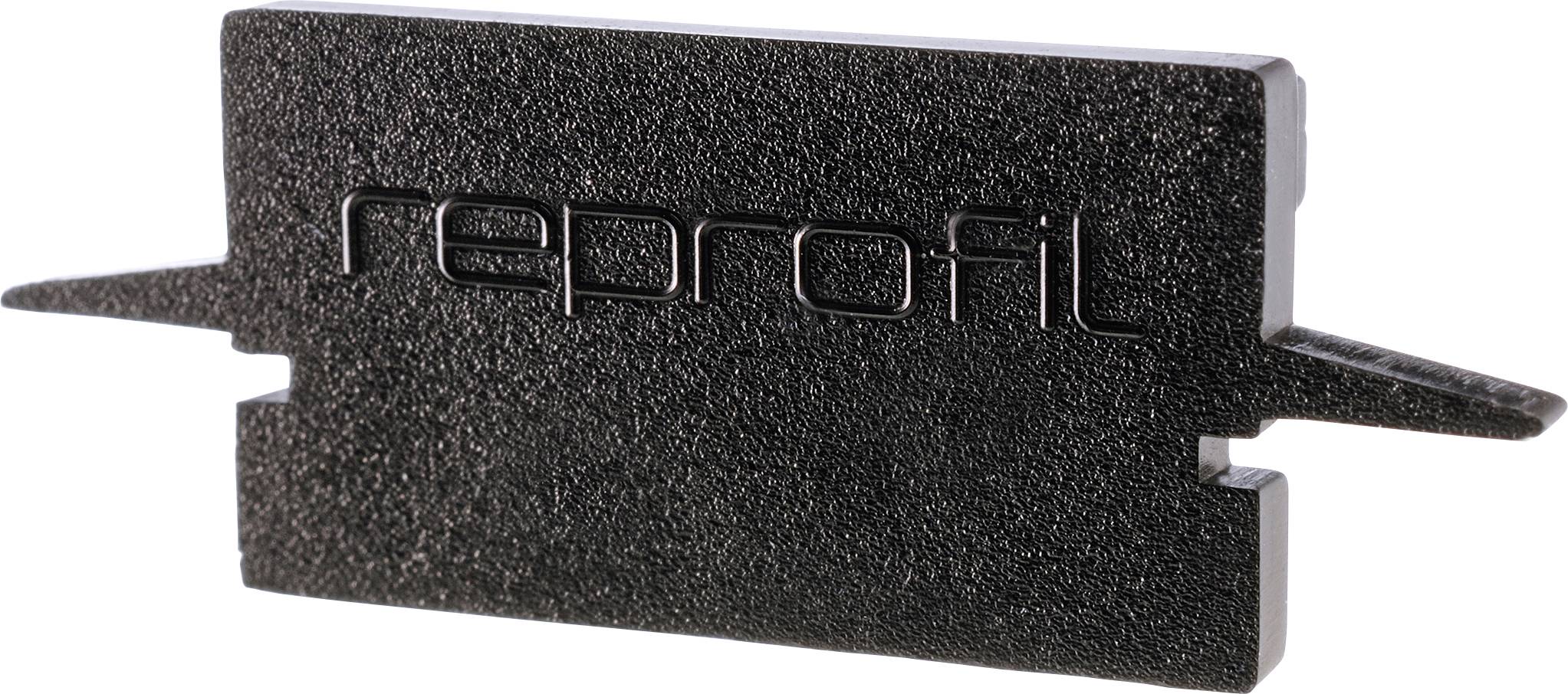 Schwarzes Kunststoffteil mit der Aufschrift 'reprofil' in erhabener Schrift, rechteckige Form mit seitlichen Vorsprüngen.