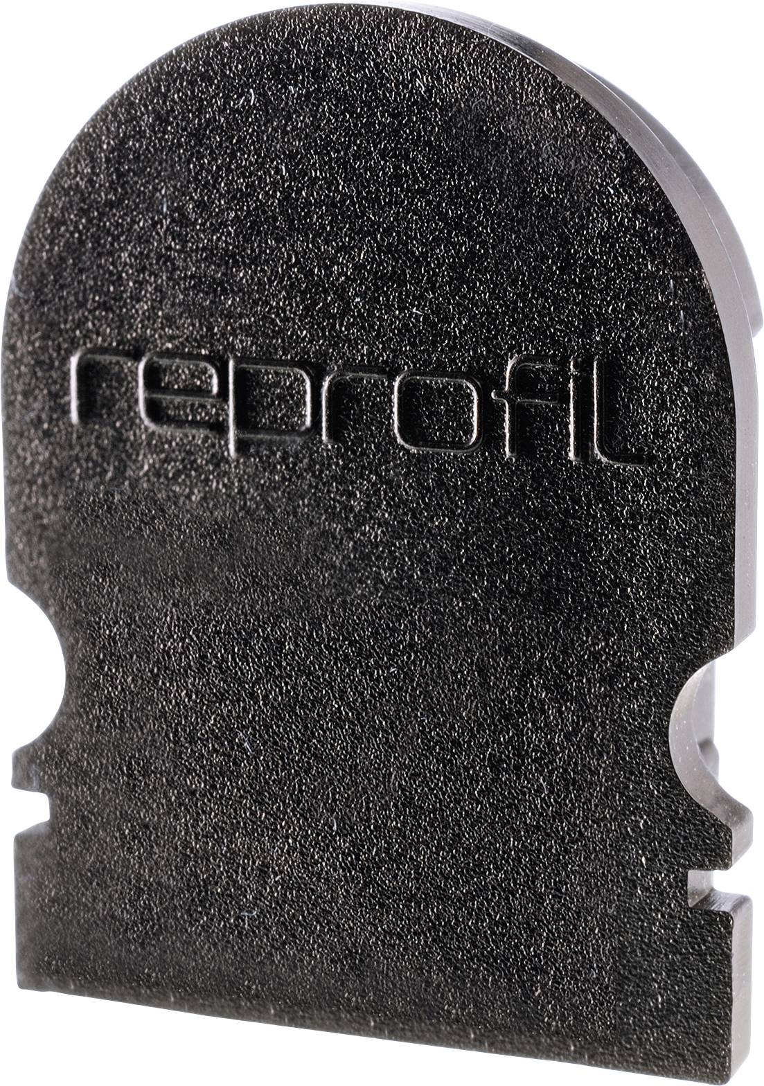 Ein dunkles Metallteil mit 'reprofil' darauf geprägt, hat eine flache und eine gerundete Seite, möglicherweise ein Maschinenwerkzeug.