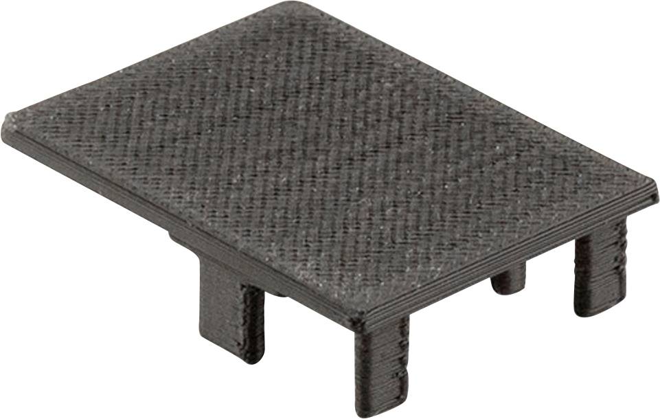 Ein rechteckiges, schwarzes Abdeckungsstück aus Kunststoff mit strukturiertem Muster und drei Stützen auf der Unterseite.