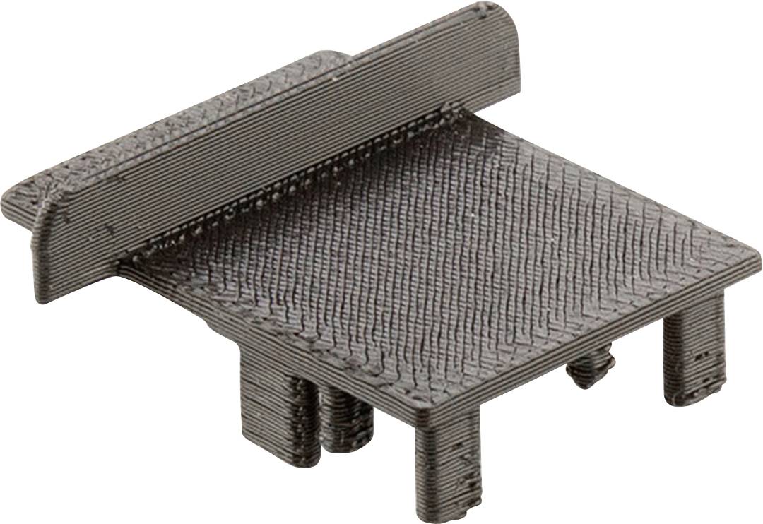 Schwarzes, rechteckiges Bauteil mit erhöhter Kante auf einer Seite und vier kurzen Beinen. Möglicher Einsatz in Maschinen oder Elektronik.