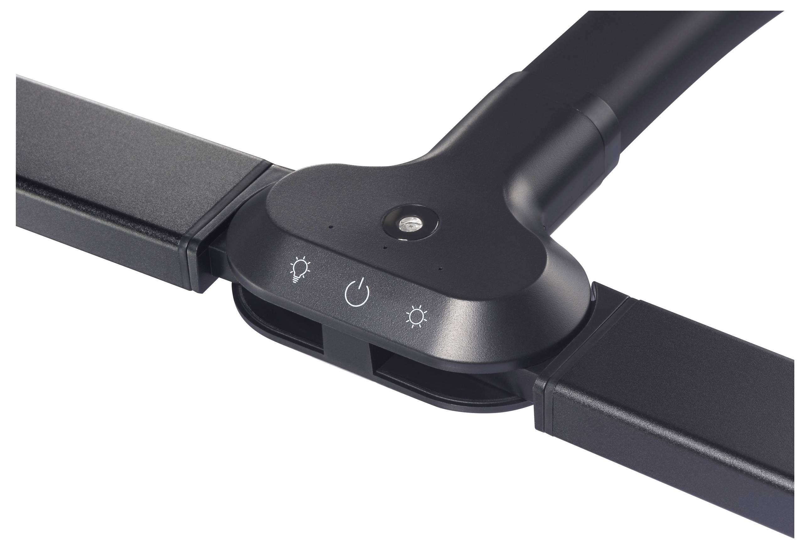 Ein schwarzer, rechtwinkliger Gegenstand mit drei Symbolen: Sonne, Kreis mit Punkt, Sonne. Er hat einen kleinen runden Knopf in der Mitte.