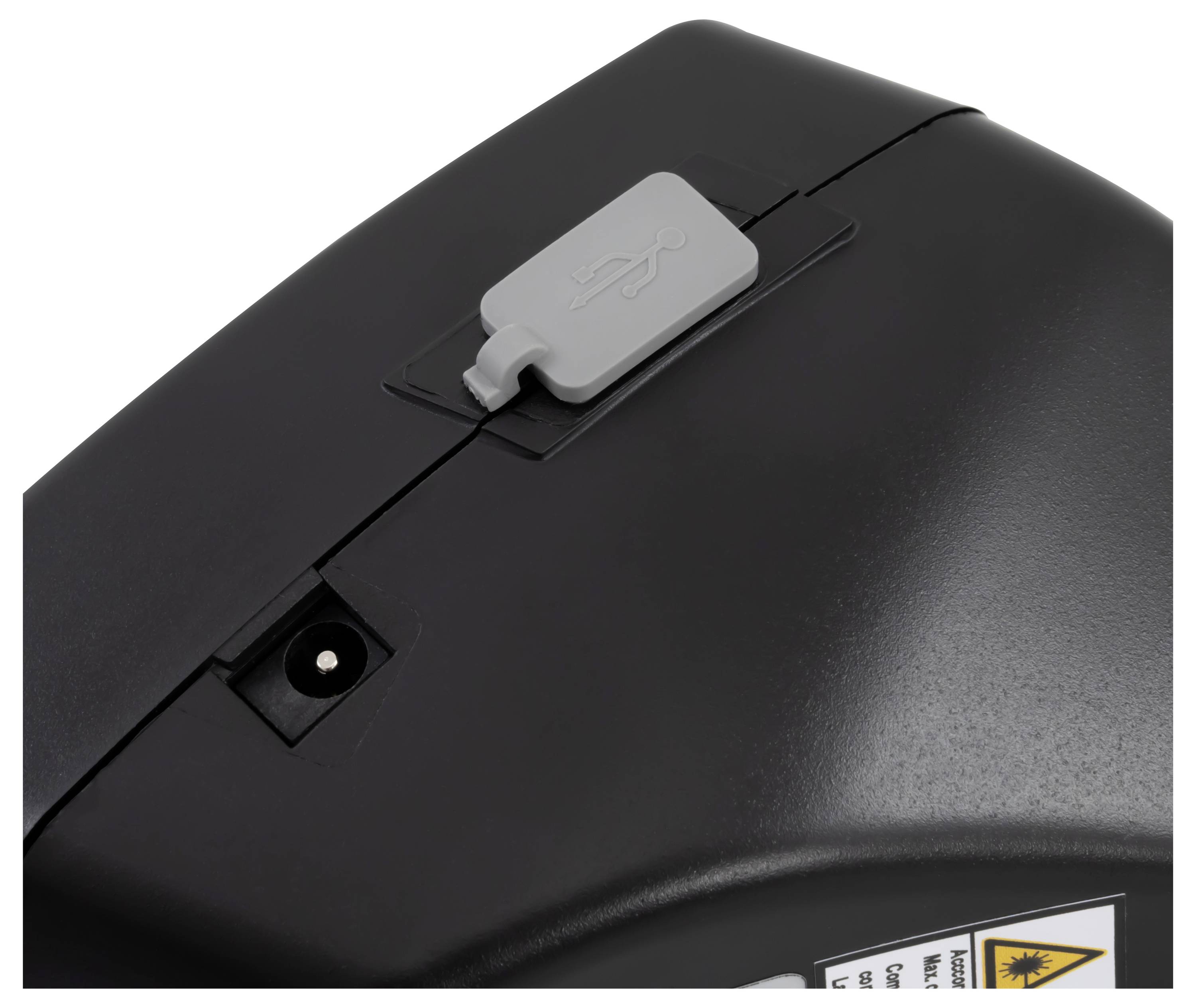 Nahaufnahme eines schwarzen Geräts oder Druckerpanels mit einer grauen USB-Abdeckung/Verschlussvorrichtung oben und einem kleinen vertieften Anschluss darunter.