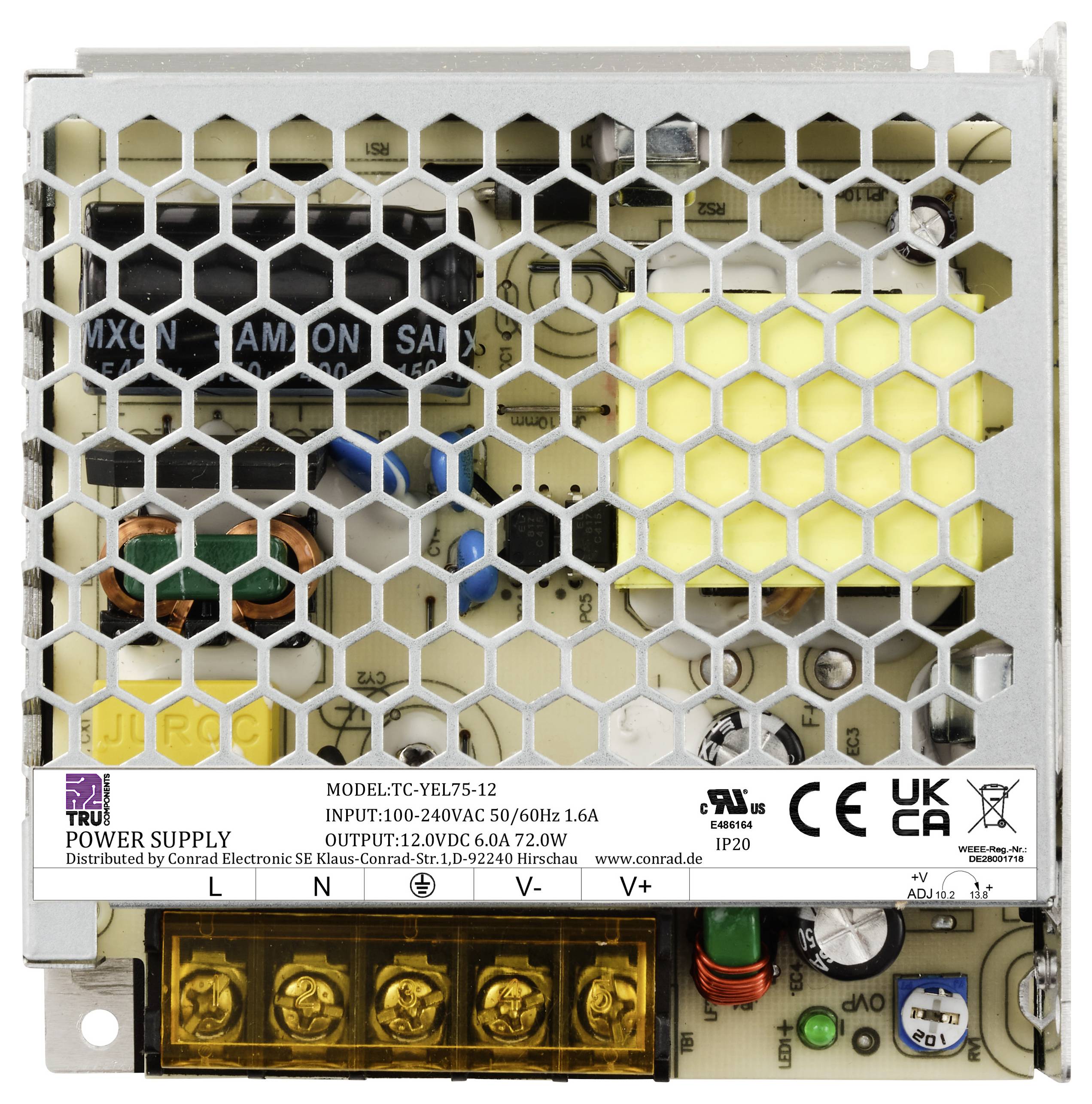 Ein offenes Computernetzteil mit Gitterabdeckung zeigt elektronische Komponenten wie Kondensatoren und Transformatoren. CE-Kennzeichnung sichtbar.
