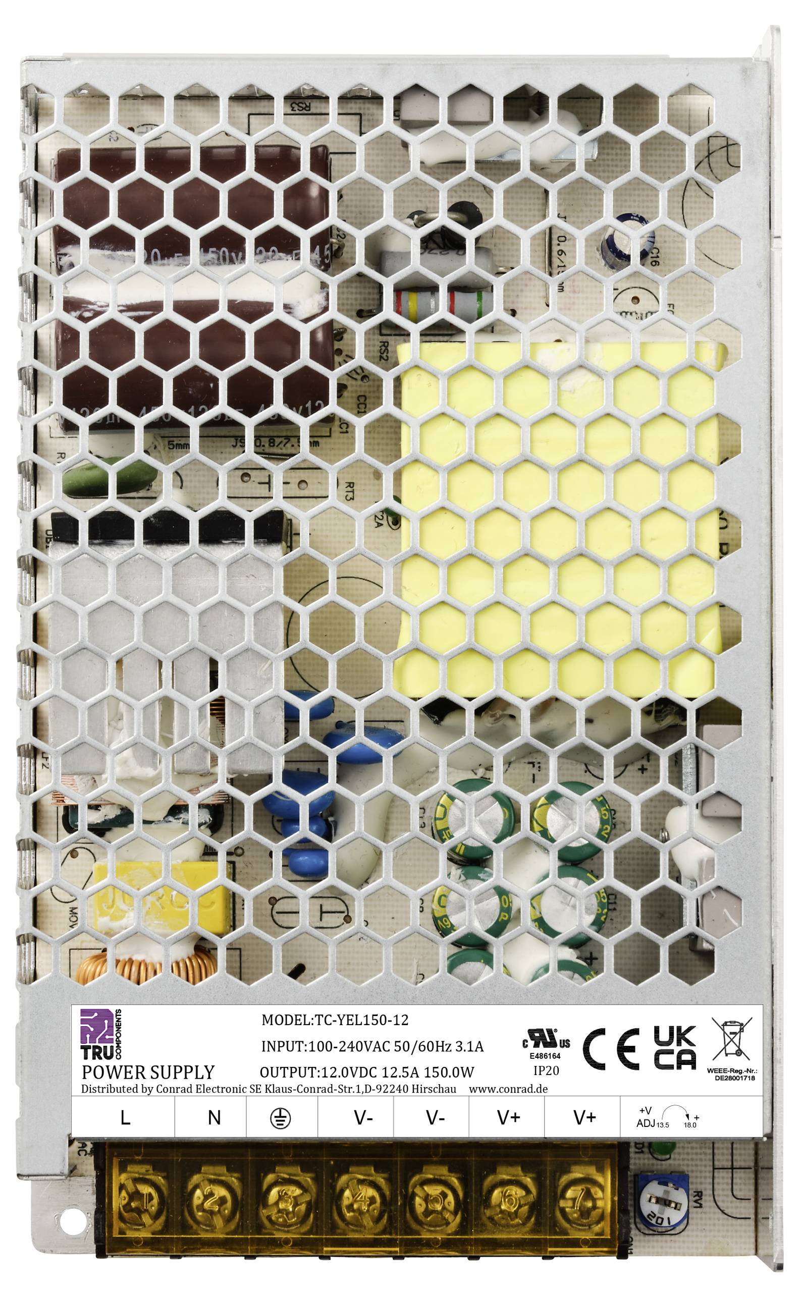 Ein offenes Schaltnetzteil mit Gittermuster zeigt interne elektronische Bauteile und technische Informationen auf einem Etikett an der Vorderseite.