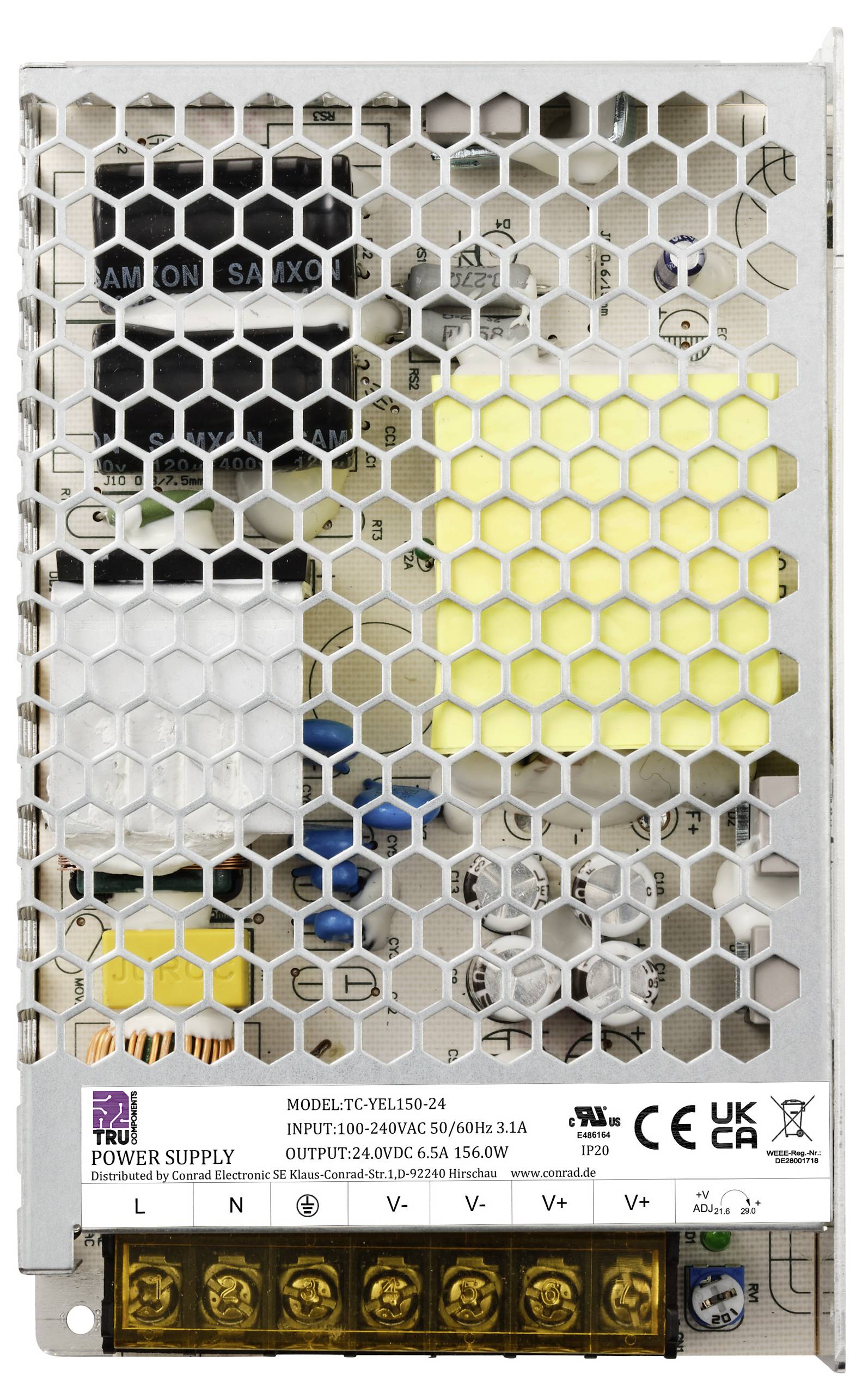 Metallgehäuse mit Lüftungsgitter eines Netzteils. Sichtbare Kabelanschlüsse und technische Kennzeichnungen auf der Vorderseite.