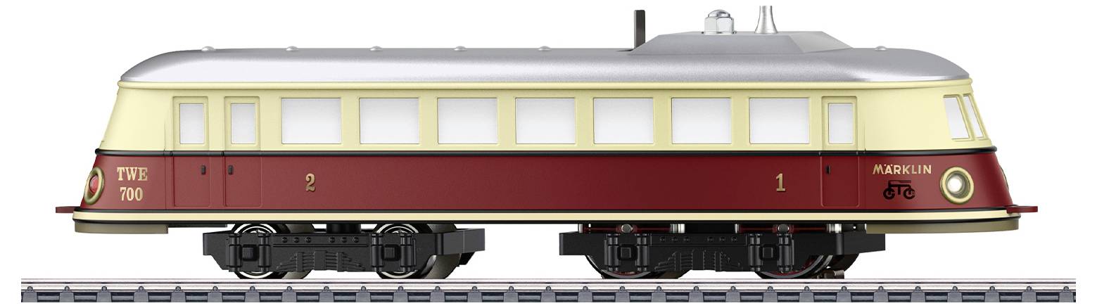 Ein Modellzug mit cremefarbenem Dach und burgunderfarbener Unterseite steht auf Gleisen. Seitlich sind die Nummern '2' und '1' sichtbar.