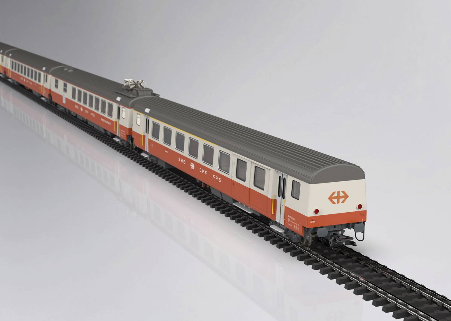 Zugmodell in rot-weiß auf Gleis. Das Modell zeigt mehrere Waggons und eine Lokomotive mit 'SBB'-Logo.