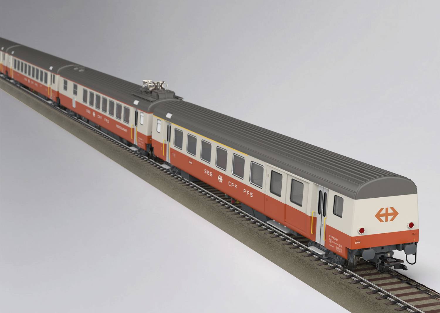 Ein Modellzug im Design der Schweizerischen Bundesbahnen in rot-weißen Farben auf einem Gleis.