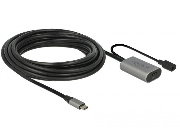 Ein langes, schwarzes USB-C-Kabel mit einem grauen Adapter, der einen USB-C- und einen Stromanschluss enthält.