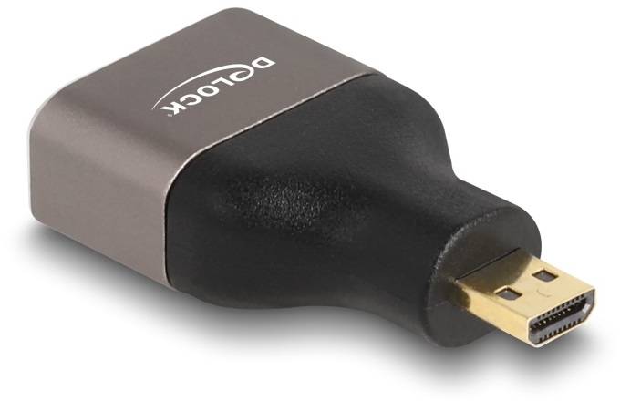 Ein Adapter mit goldenem HDMI-Anschluss in rechteckiger Form, Markenname 'Delock' auf der Oberseite.