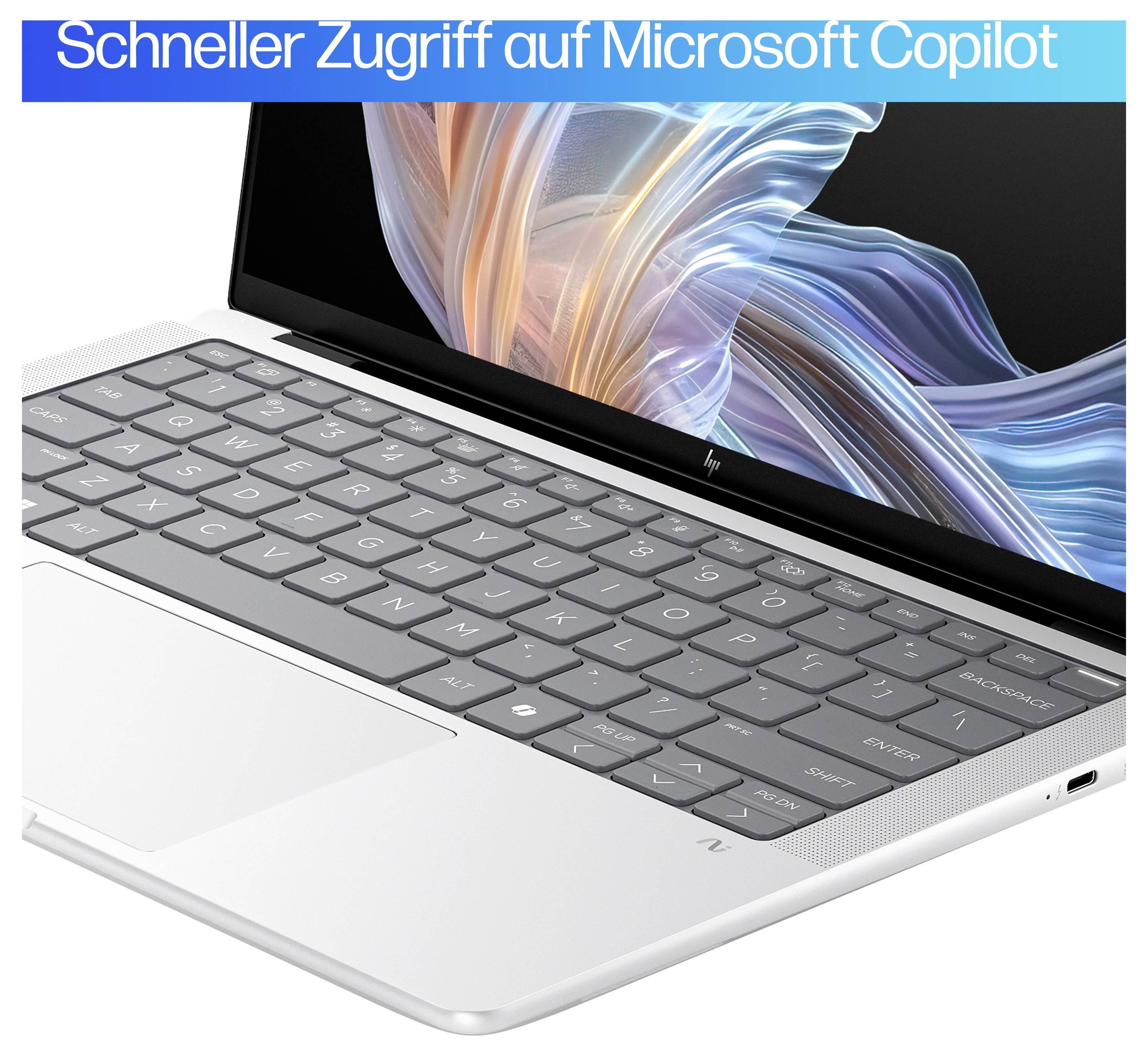 Laptop mit geöffneter Anzeige und Tastatur. Oben im Bild steht: 'Schneller Zugriff auf Microsoft Copilot'.