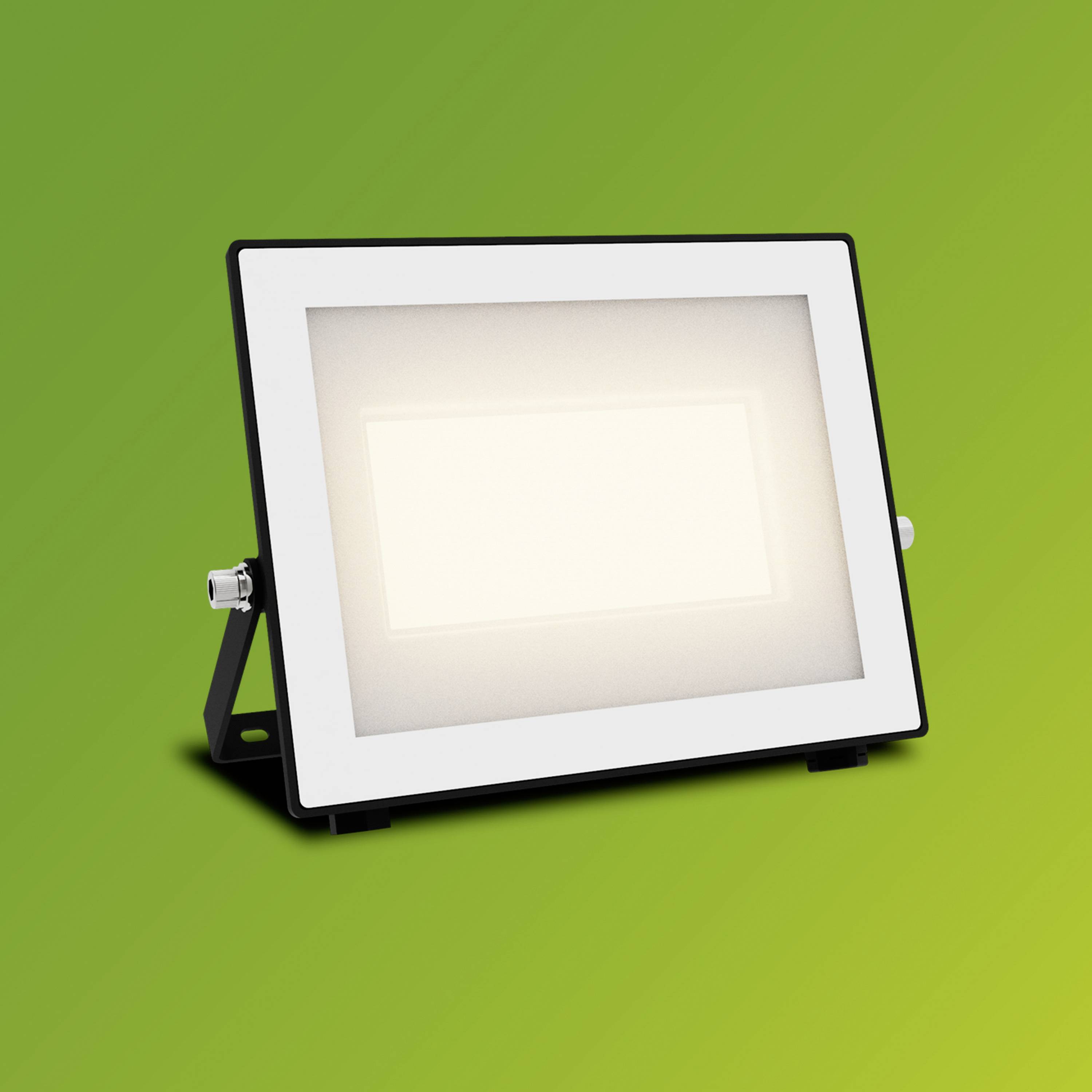 Ein rechteckiger LED-Strahler leuchtet hell auf einem grün-gelben Hintergrund.