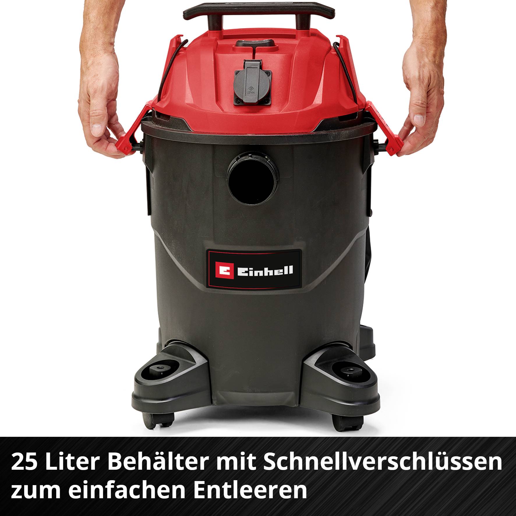 Eine Person hält einen Einhell Industriesauger mit schwarzem 25-Liter-Behälter und roten Griffen. Text: '25 Liter Behälter mit Schnellverschlüssen zum einfachen Entleeren'.