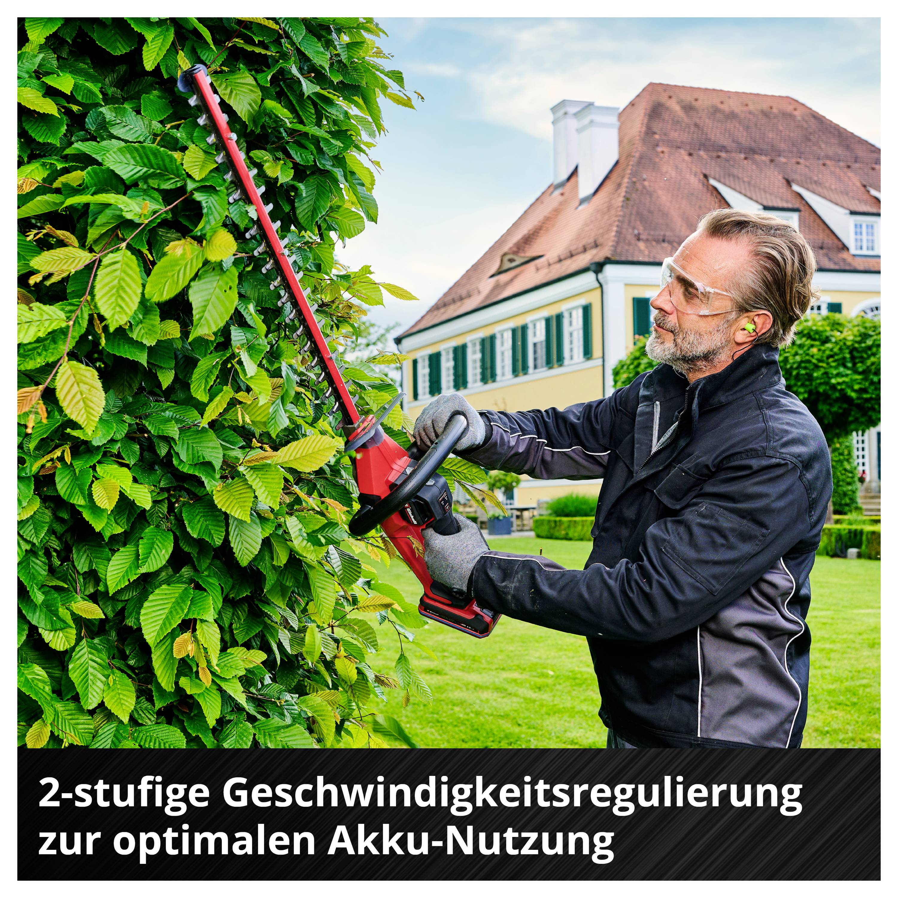 Mann schneidet mit einer Akku-Heckenschere eine Hecke vor einem Haus; Text unten: '2-stufige Geschwindigkeitsregulierung zur optimalen Akku-Nutzung'.