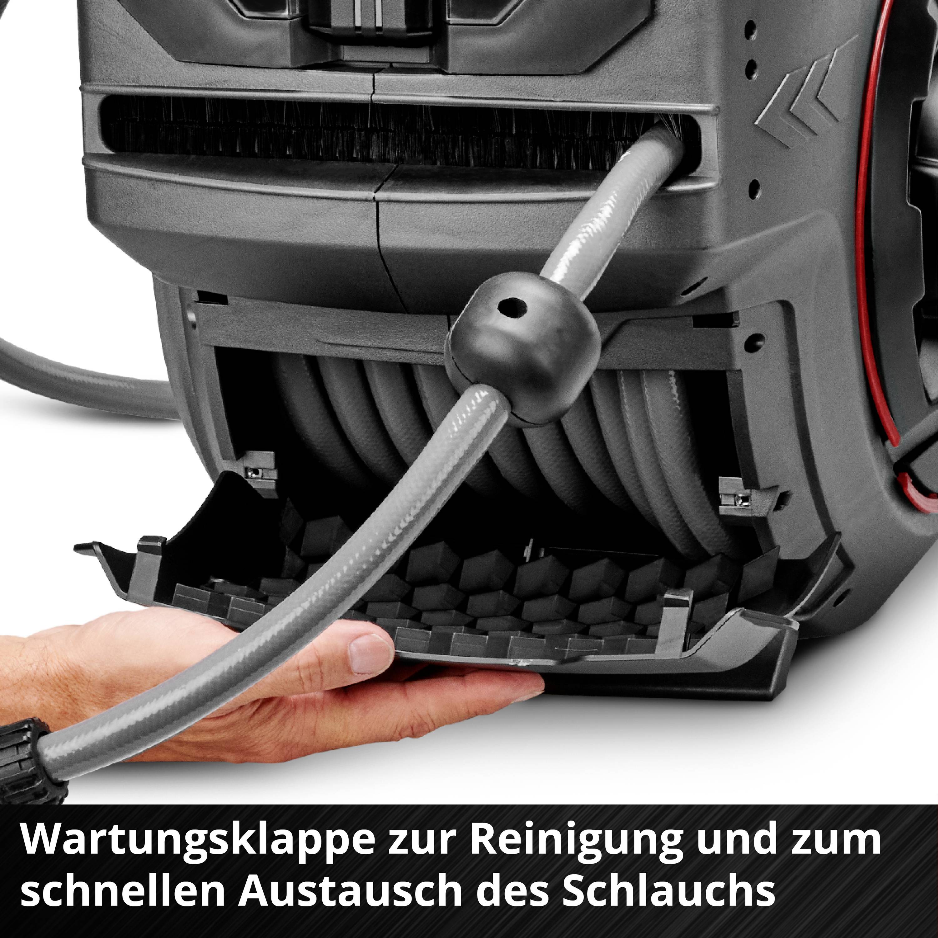 Eine Hand öffnet die Wartungsklappe eines Geräts, um den Schlauch zu reinigen. Text: 'Wartungsklappe zur Reinigung und zum Wartungsabschluss des Schlauchs'.
