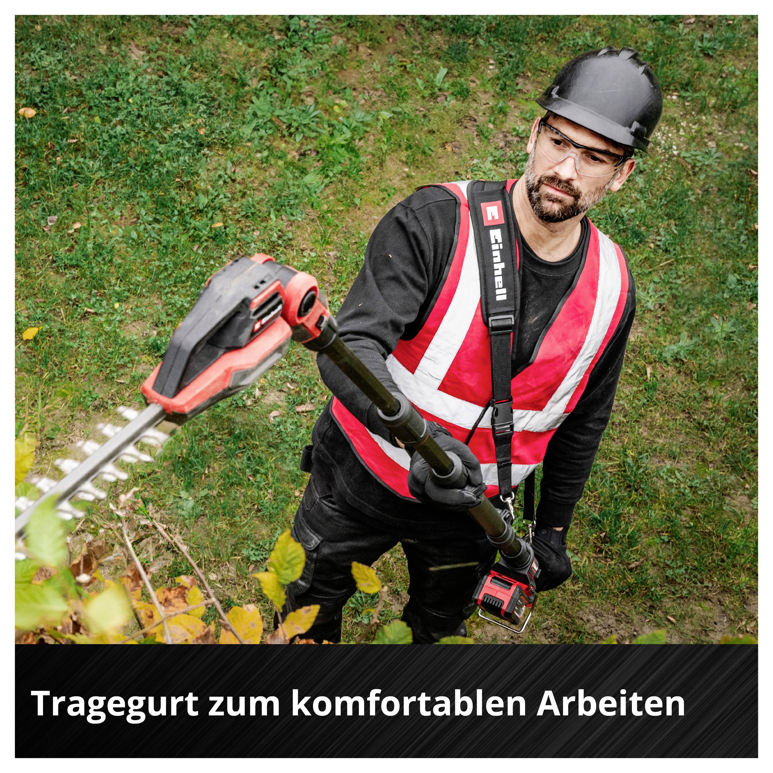 Arbeiter mit Schutzhelm und Warnweste bedient eine Stab-Heckenschere; unten steht 'Tragegurt zum komfortablen Arbeiten'.