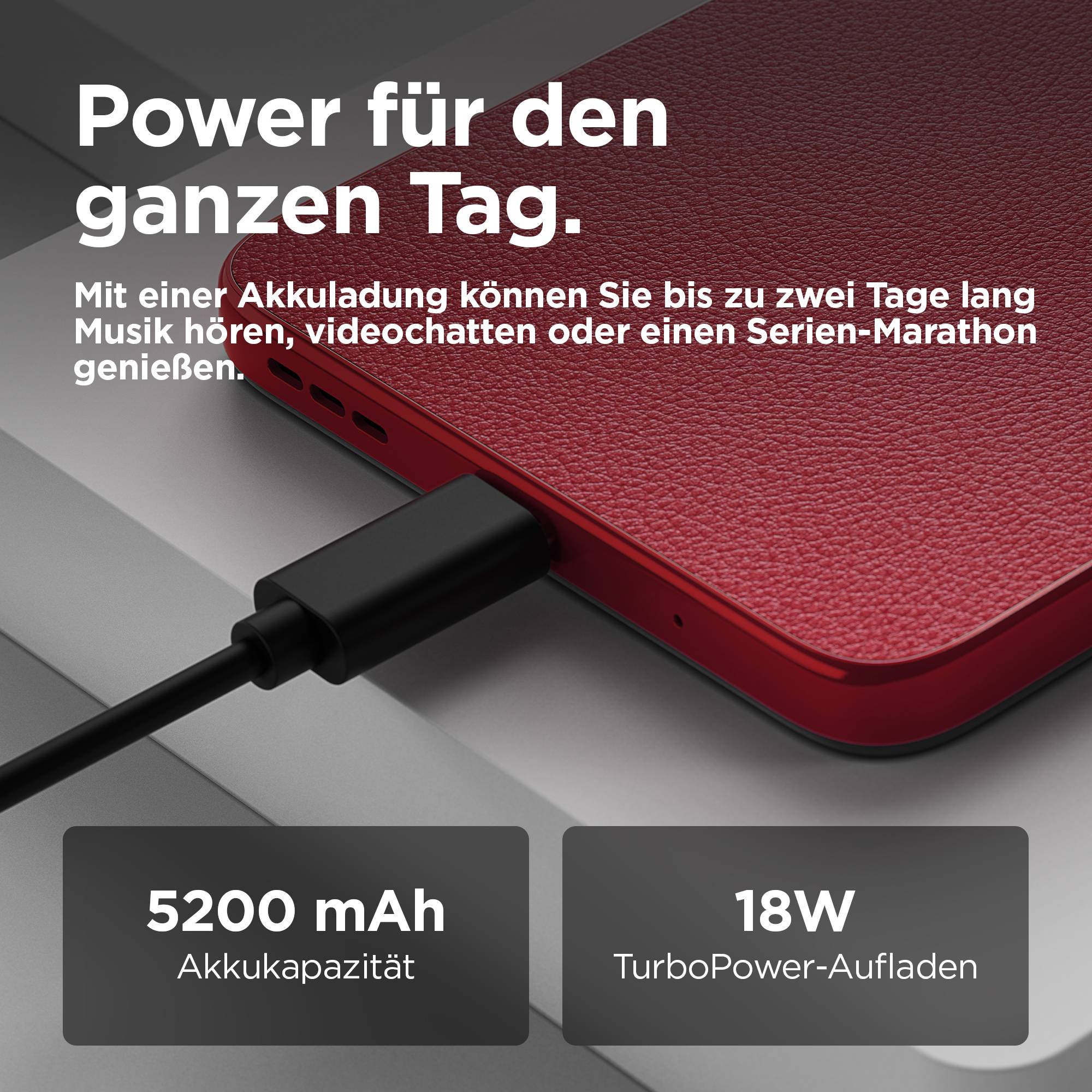 Smartphone auf einer Tischoberfläche, verbunden mit Ladekabel. Text: 'Power für den ganzen Tag. 5200 mAh Akkukapazität, 18W TurboPower-Aufladen.'